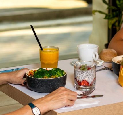 Two woman eating tasty chicken salads with dessert